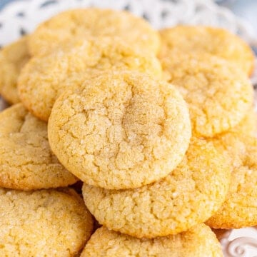 A pile of soft and chewy sugar cookies with sparkly sugar tops
