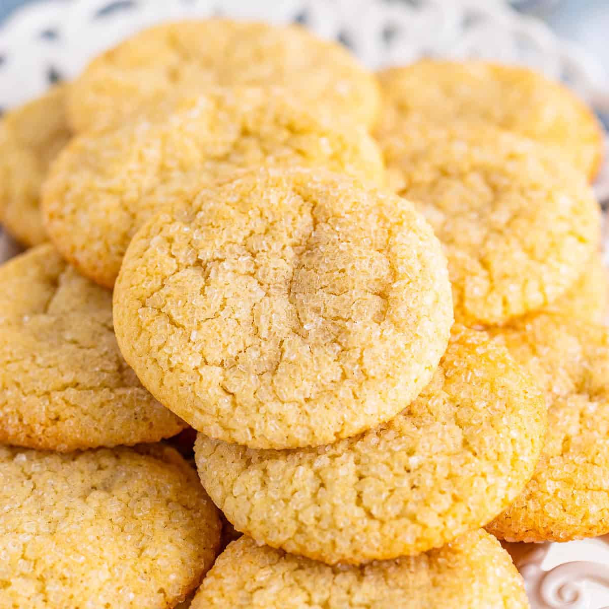 A pile of soft and chewy sugar cookies with sparkly sugar tops
