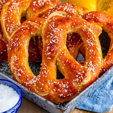A tray of homemade soft pretzels with a golden crust and sprinkled with pretzel salt.