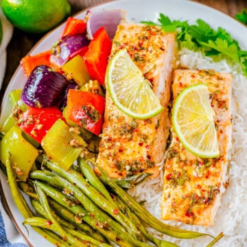 Square image of dinner on plate served over rice.