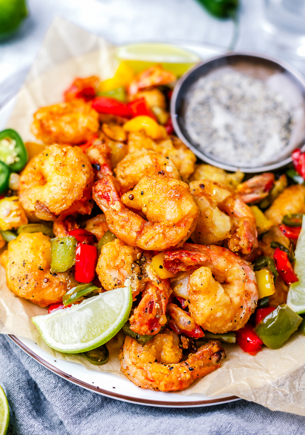 Finished Salt and Pepper Shrimp plated with lime wedges.