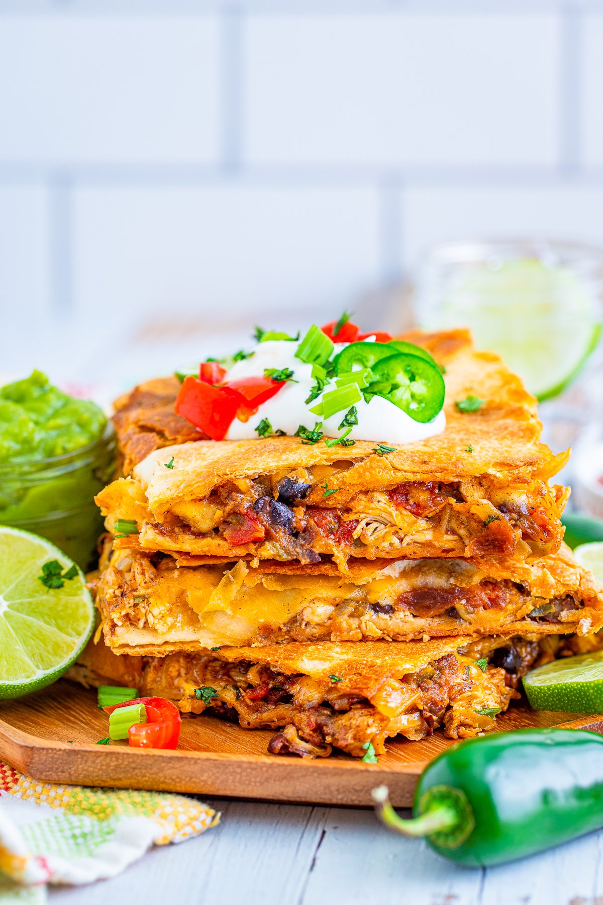 Stacked Chicken Quesadilla with toppings.