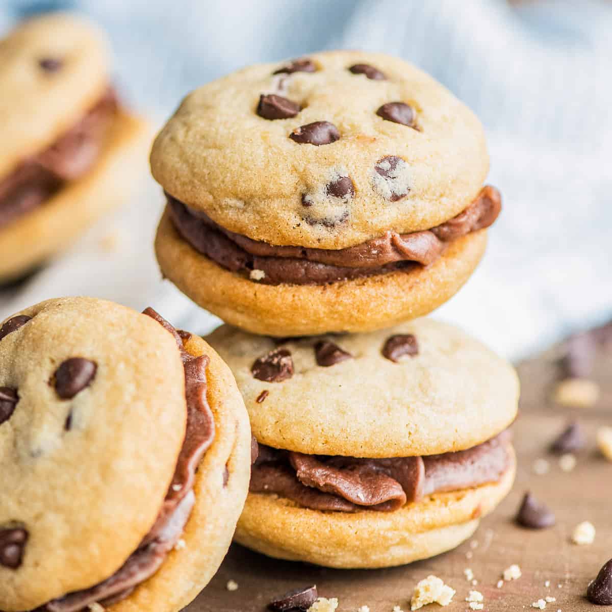 Two stacked Chocolate Chip Cookie Sandwiches filled with swirls of chocolate buttercream.