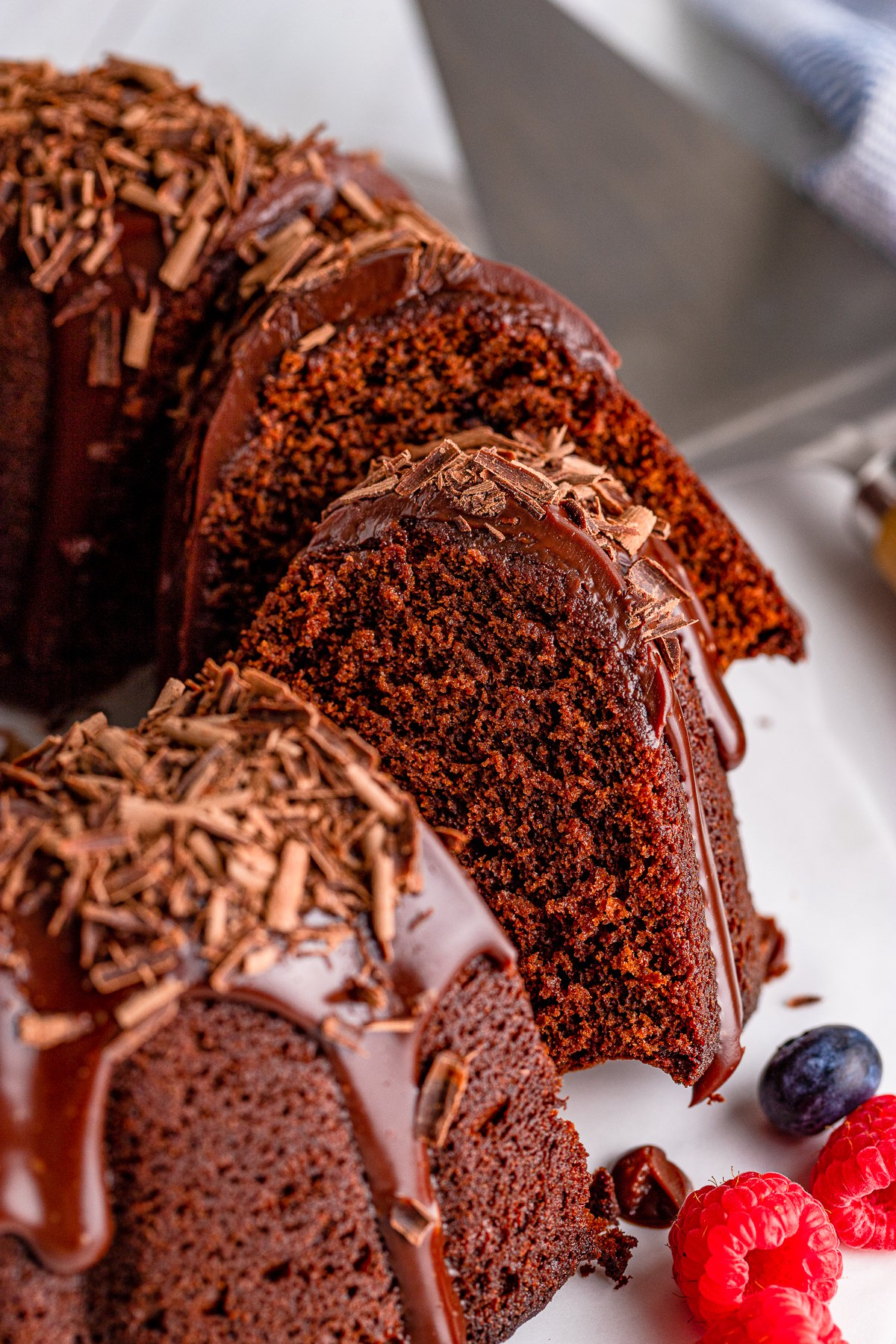 Chocolate Bundt Cake sliced with layers laying on other slices of cake.