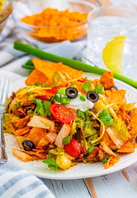 Doritos Taco Salad on plate with toppings.