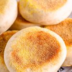 Stacked finished English Muffins on plate.