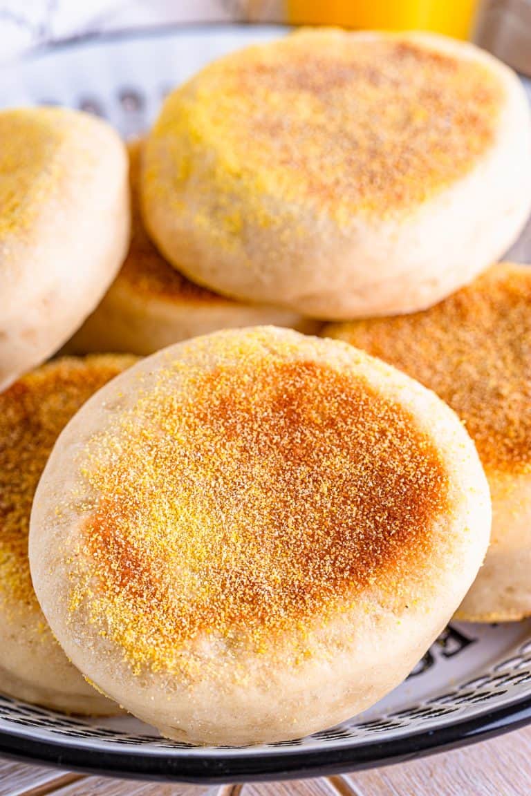 Stacked finished English Muffins on plate.