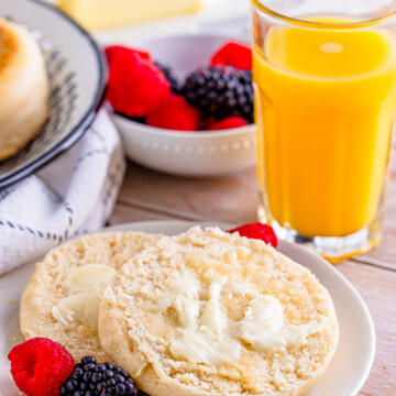 Split English Muffin Recipe on plate with butter.