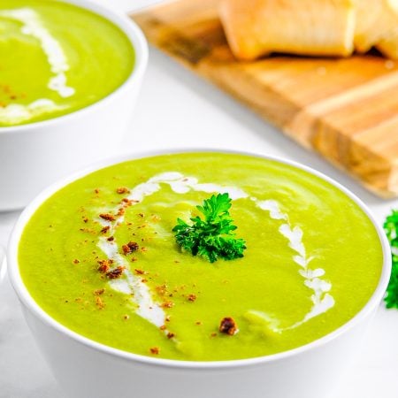 Garnished Pea Soup Recipe in white bowl.