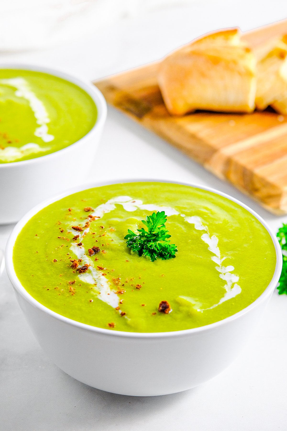 Garnished Pea Soup Recipe in white bowl.