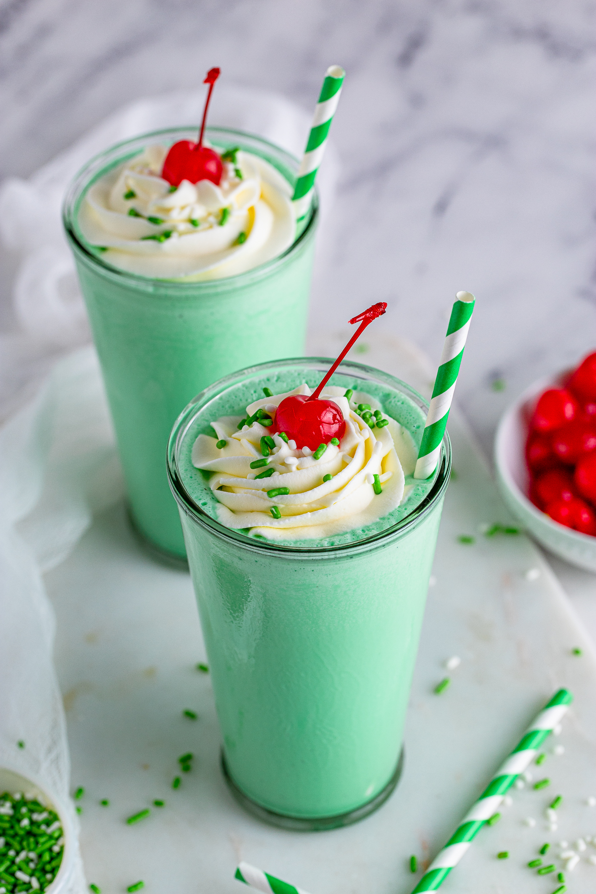 Overhead of two Shamrock Shake Recipe with toppings.