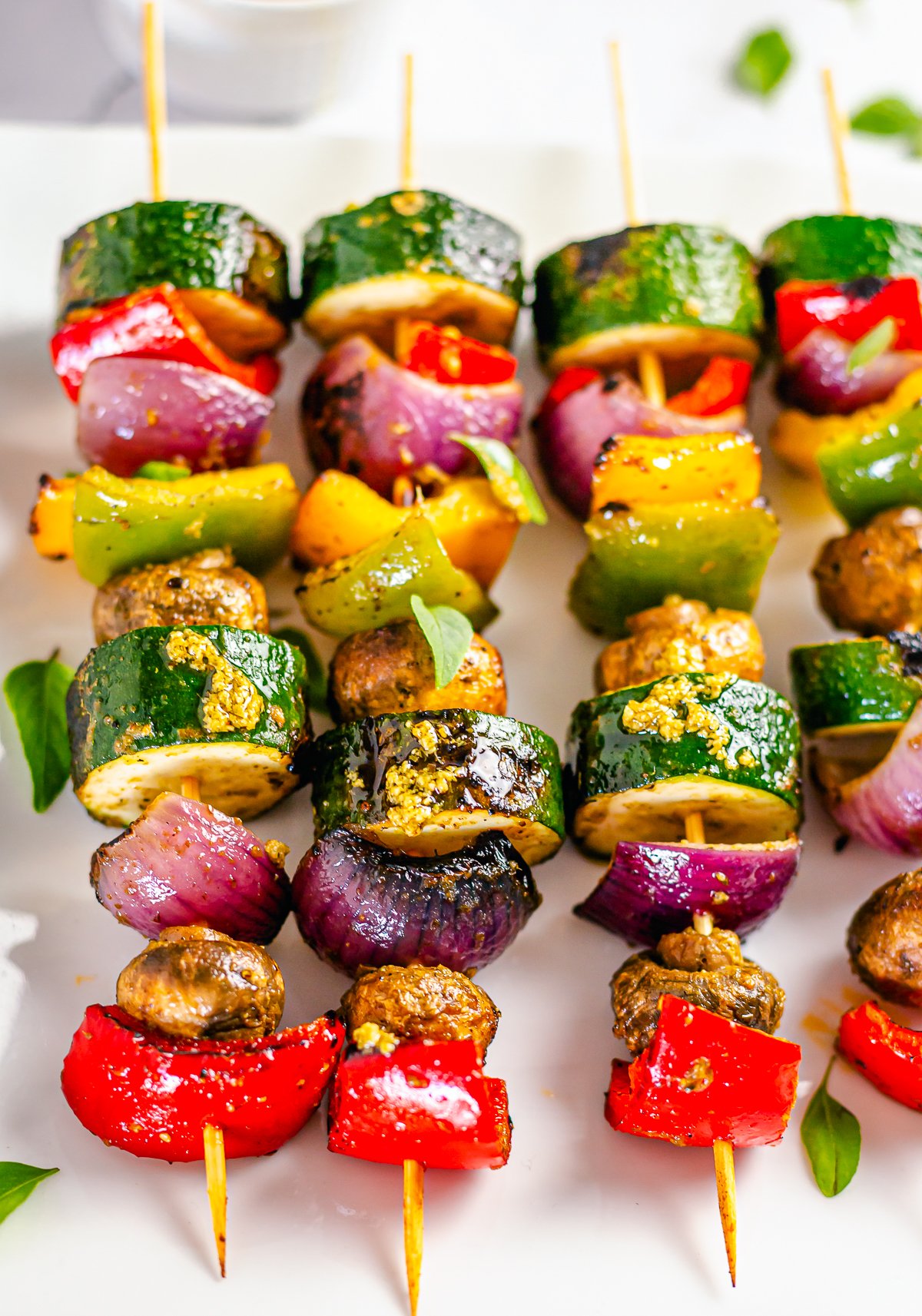 Close up overhead of Grilled Vegetable Kebabs on white platter.