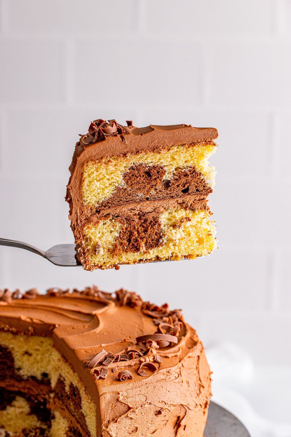 Cake server holding up a slice of the Marble Cake Recipe.