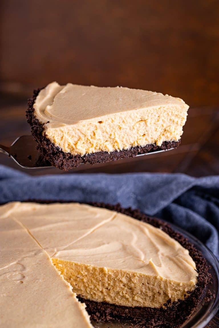 A no bake peanut butter pie with an Oreo crust, drizzled with chocolate and topped with whipped cream.