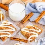 Overhead of glazed Cinnamon Roll Blondies with milk and cinnamon sticks.