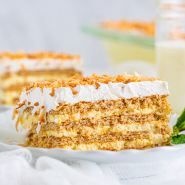 One slice of Coconut Icebox Cake on white plate showing layers.