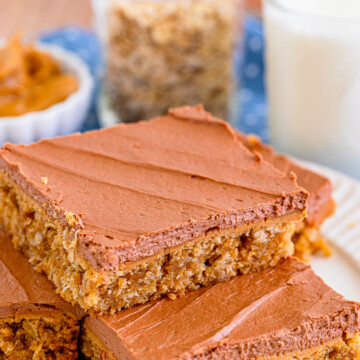 Stacked Lunch Lady Peanut Butter Bars on white plate.
