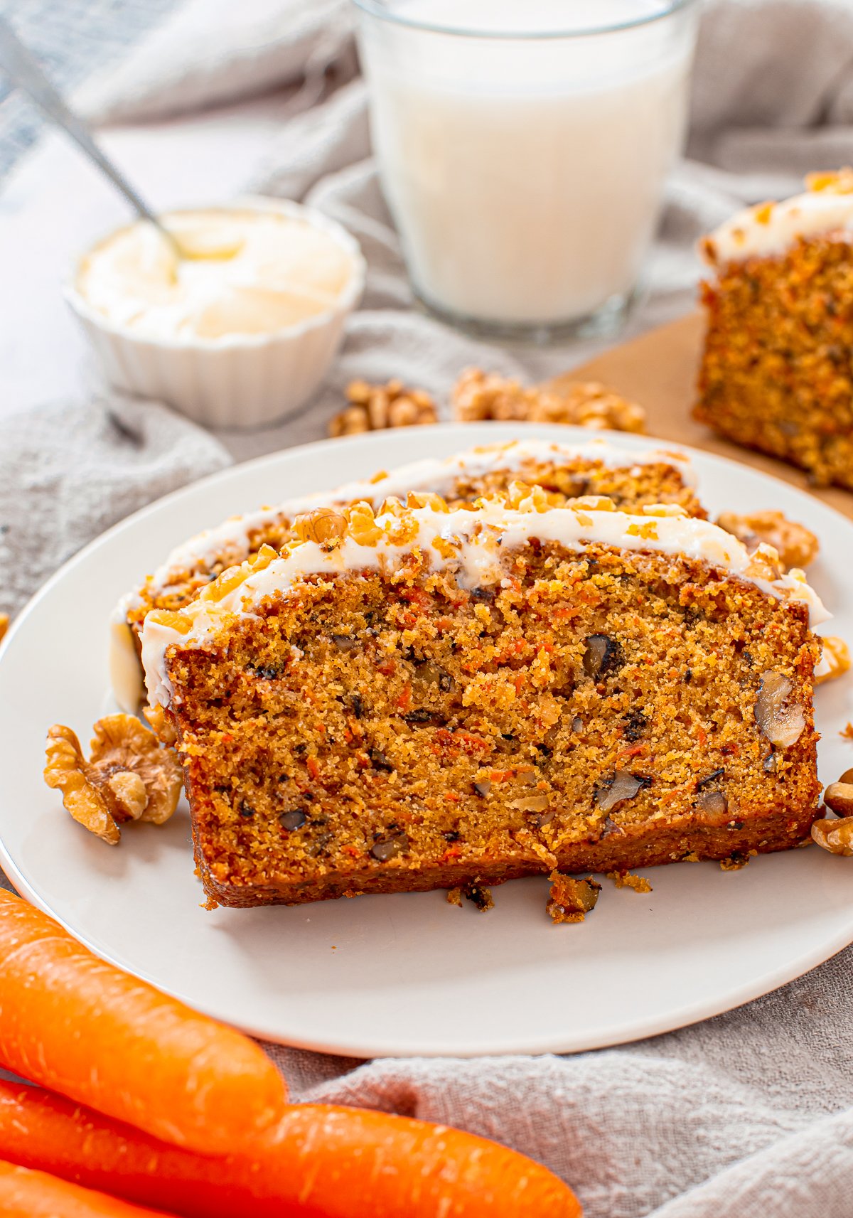 Two slices of the Carrot Loaf Cake on white plate.