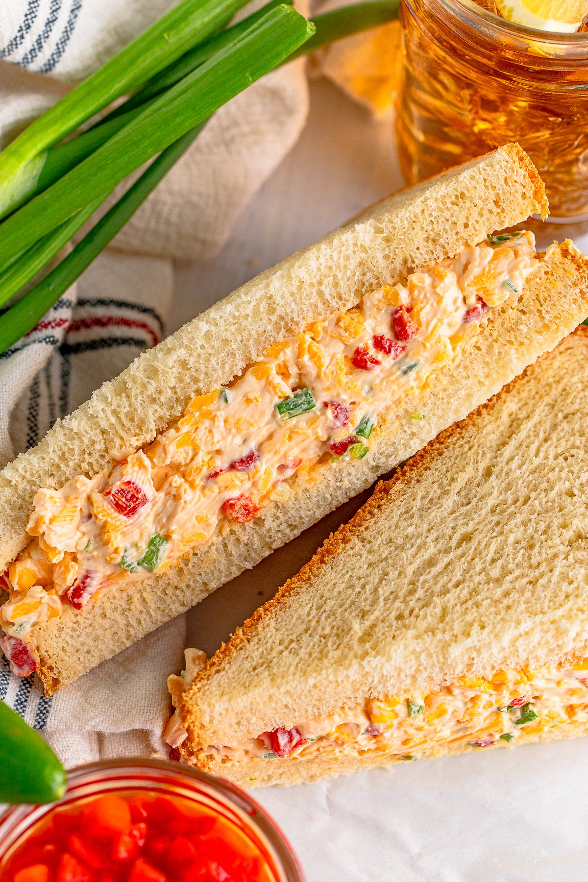 Pimento Cheese Recipe in sandwich with one cut side facing up showing filling.