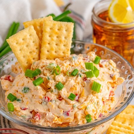 Pimento Cheese Recipe in bowl with crackers sticking out of it.