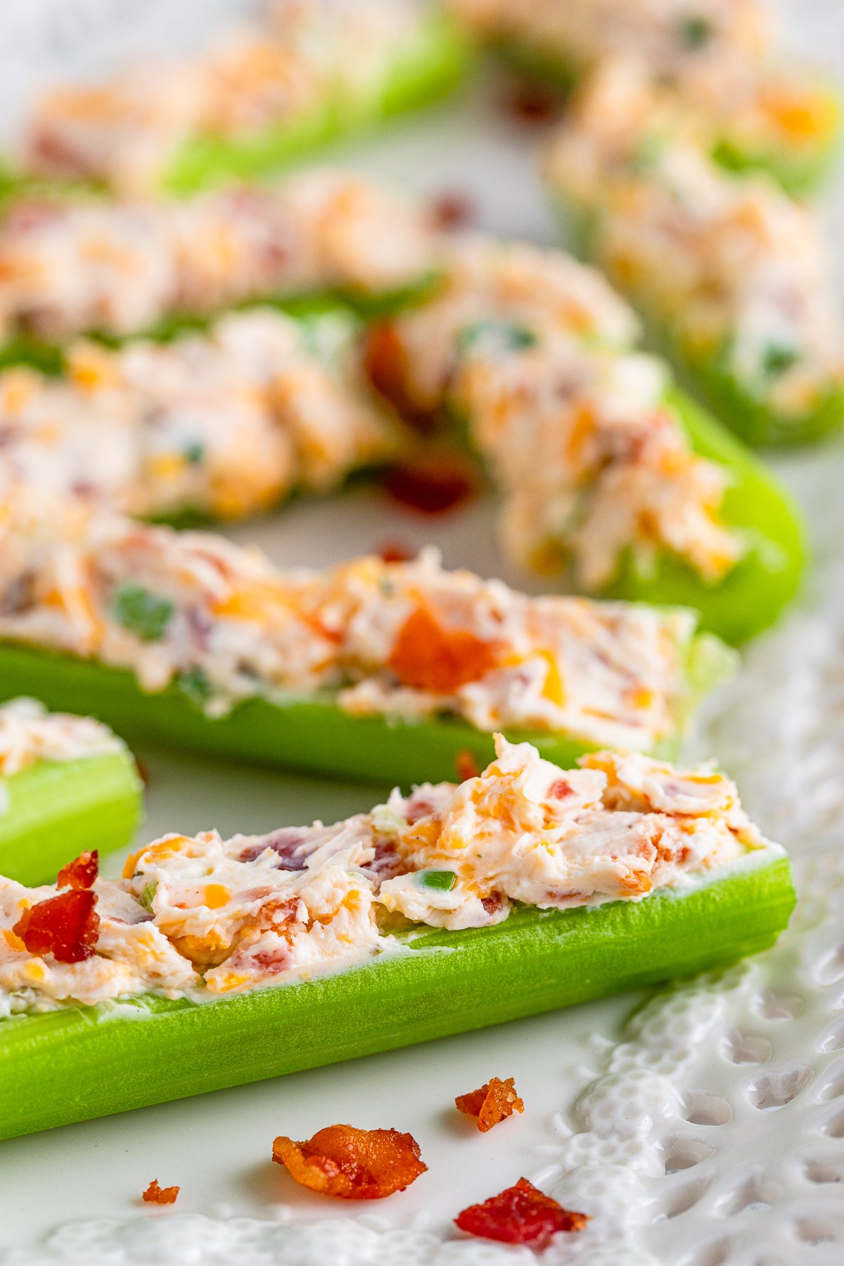 Close up of Stuffed Celery Sticks on platter showing stuffing ingredients.