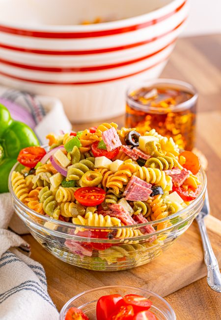 Classic Pasta Salad in bowl with tea in background.