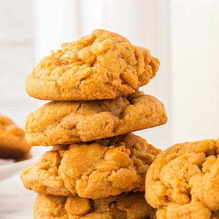 Stacked Butterscotch Cookies next to milk.