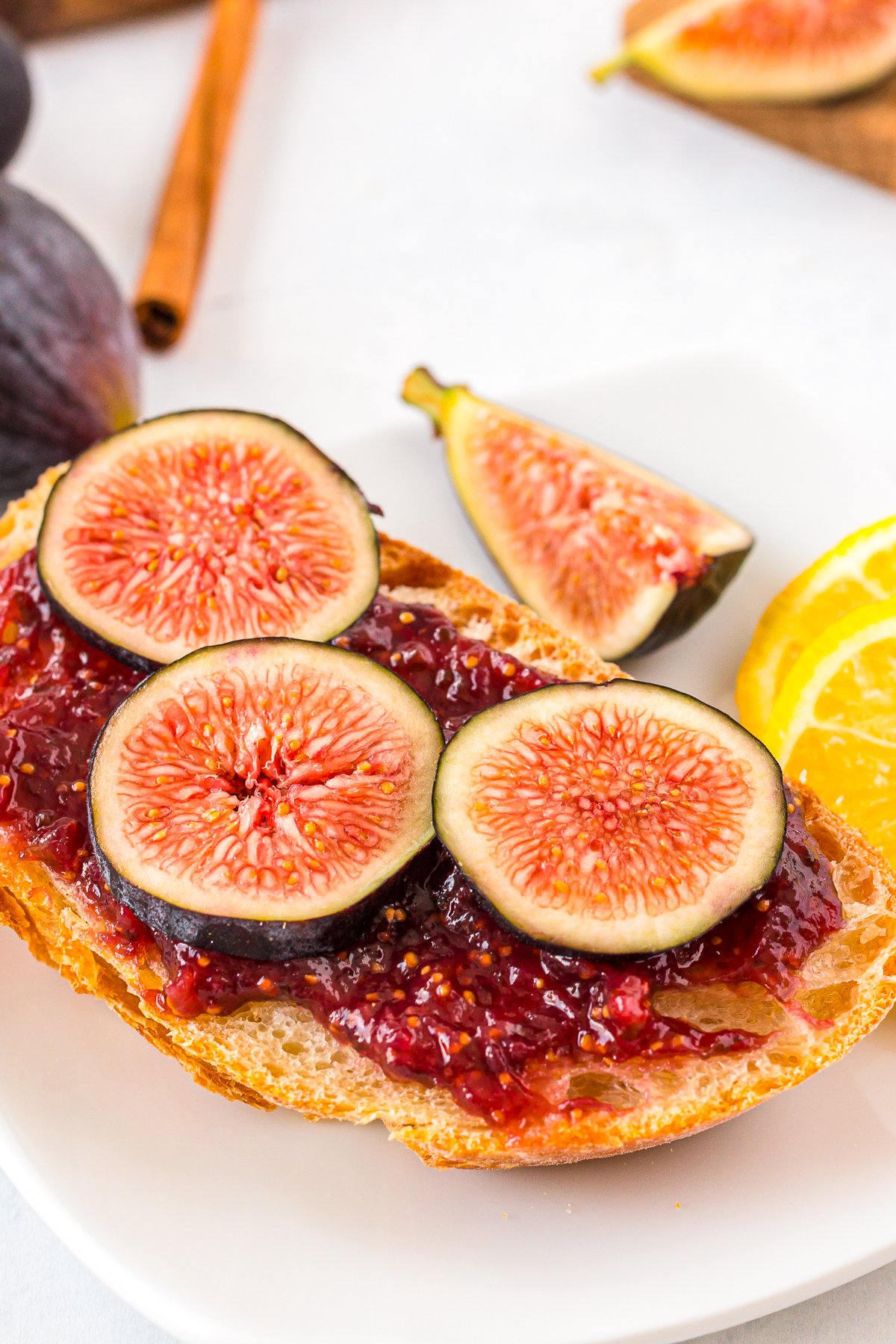 Fig Jam Recipe spread on toast with fresh cut figs on top.