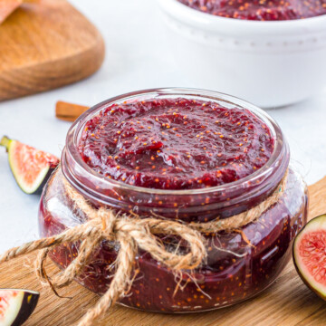 Fig Jam Recipe in a jar with string and figs cut around it.