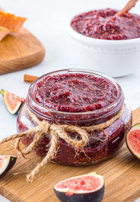 Fig Jam Recipe in a jar with string and figs cut around it.