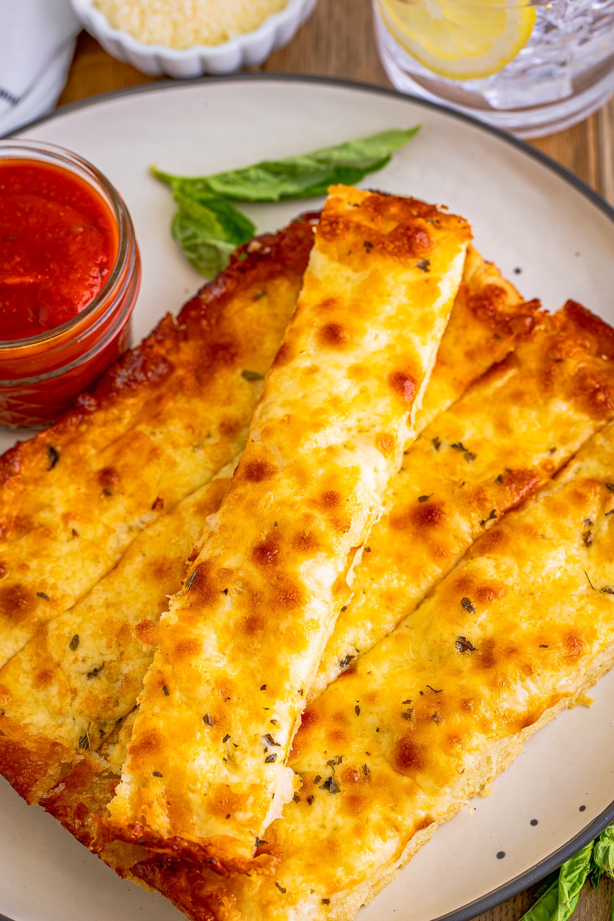 Overhead of Pizza Hut Cheese Sticks on plate with marinara sauce.