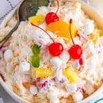 Overhead photo of Ambrosia Salad Recipe showing ingredients topped with cherries.rosia Salad