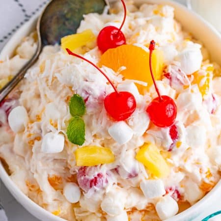 Overhead photo of Ambrosia Salad Recipe showing ingredients topped with cherries.rosia Salad