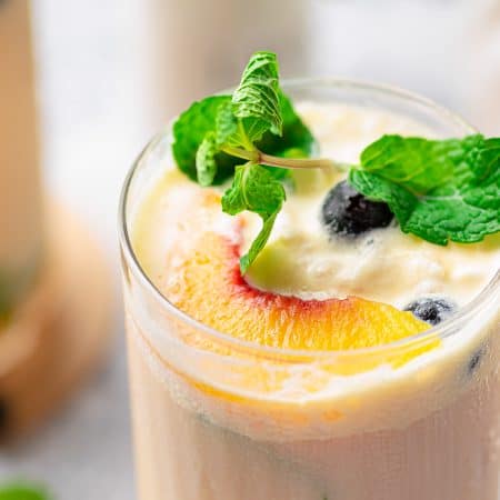 Close up overhead of Creamy Peach Tea showing garnishes.