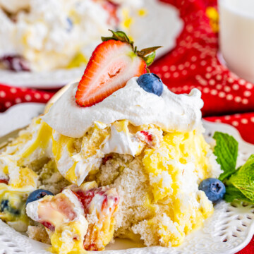 Patriotic Trifle on white plate topped with a strawberry.