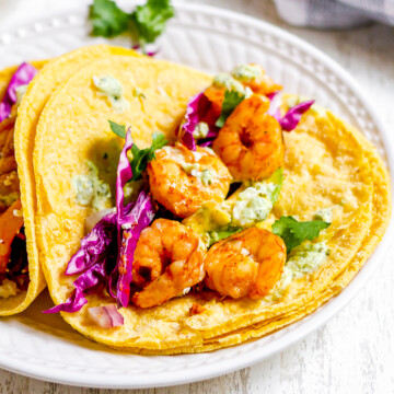 close up shot of plated spicy shrimp tacos