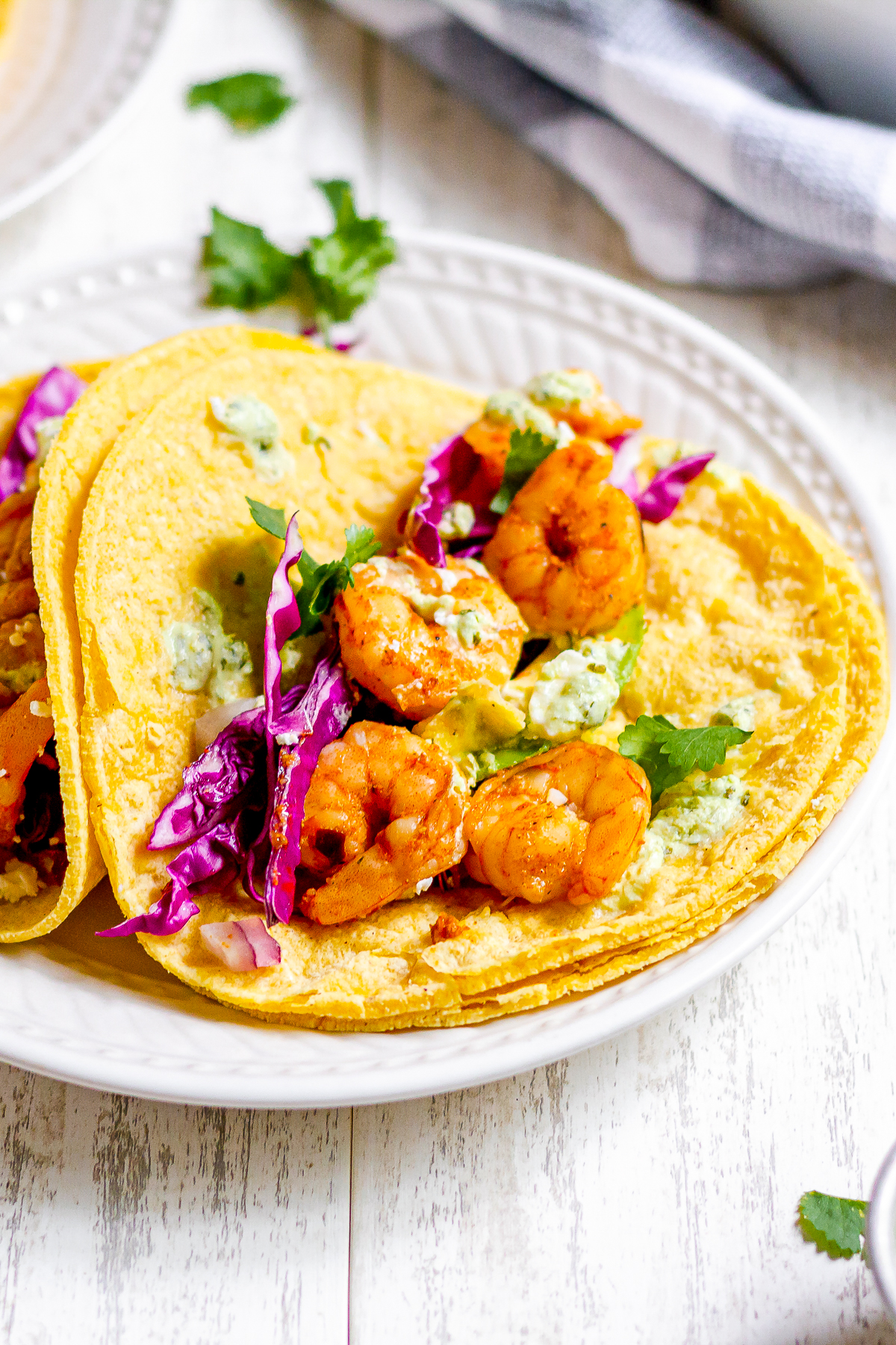 close up shot of plated spicy shrimp tacos