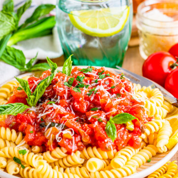 Tomato Basil Sauce served over pasta with basil garnish.