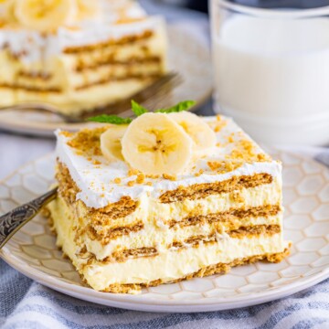 Slice of Banana Icebox Cake on plate with toppings.