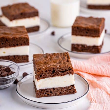 A stack of brownie ice cream sandwiches with vanilla ice cream between fudgy brownie layers.