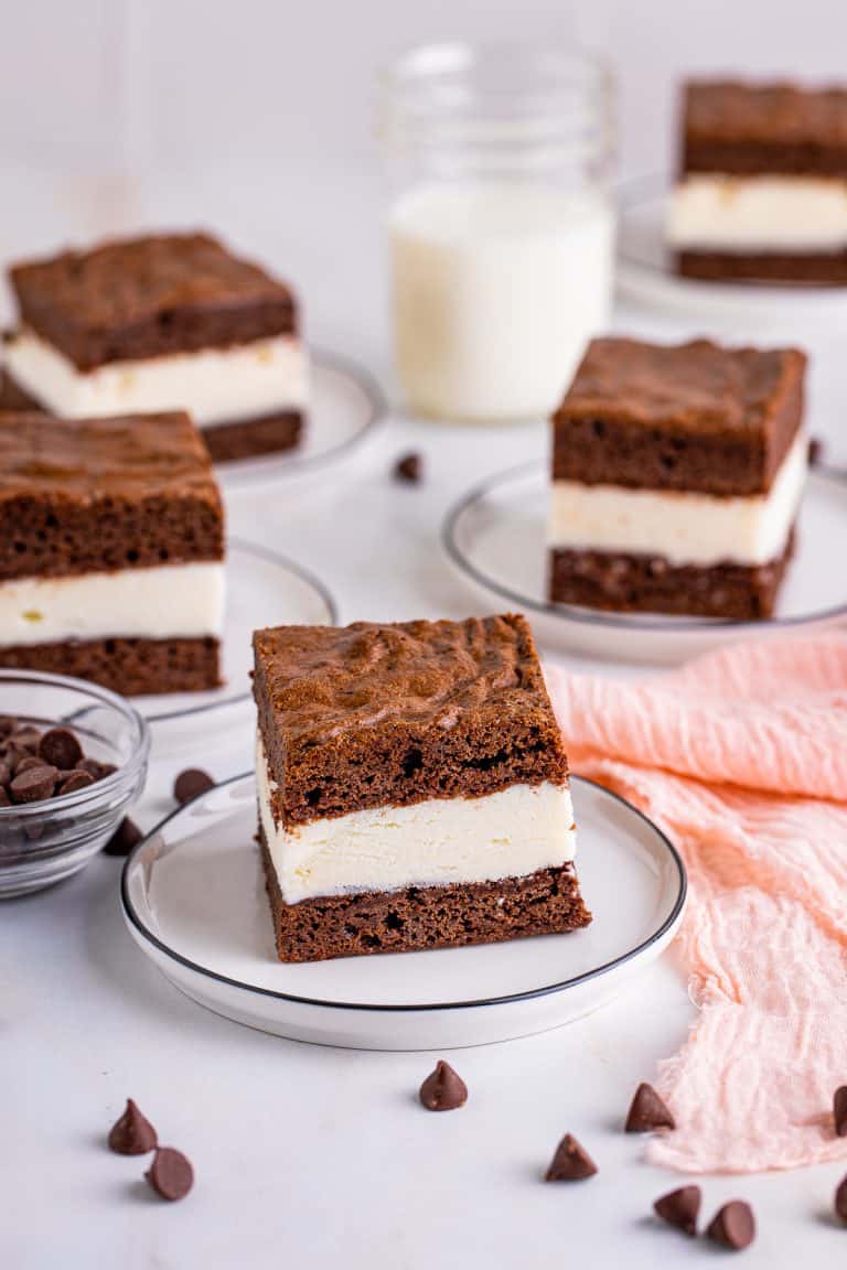 A stack of brownie ice cream sandwiches with vanilla ice cream between fudgy brownie layers.