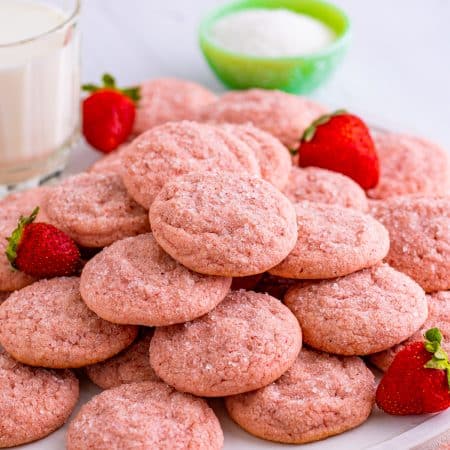 Strawberry Sugar Cookies stacked on white platter.