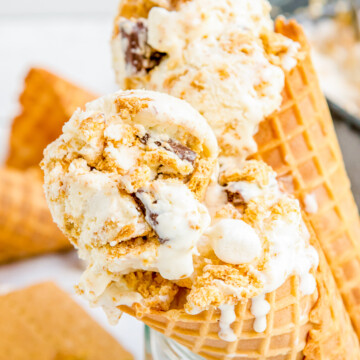 Two ice cream cones filled with ice cream.