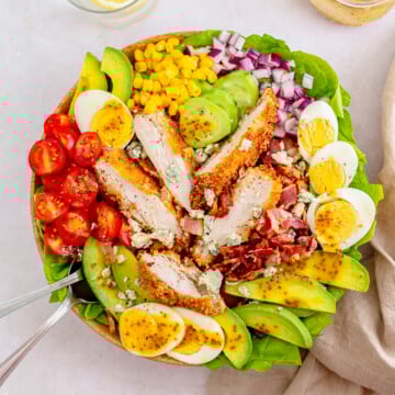 Overhead of finished Chicken Cobb Salad with forks in side.