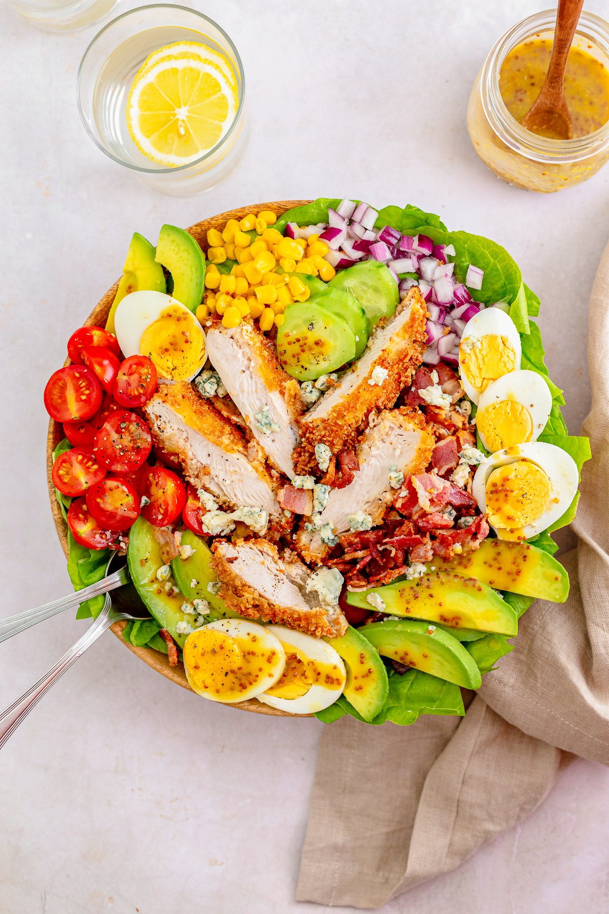 Overhead of finished Chicken Cobb Salad with forks in side.