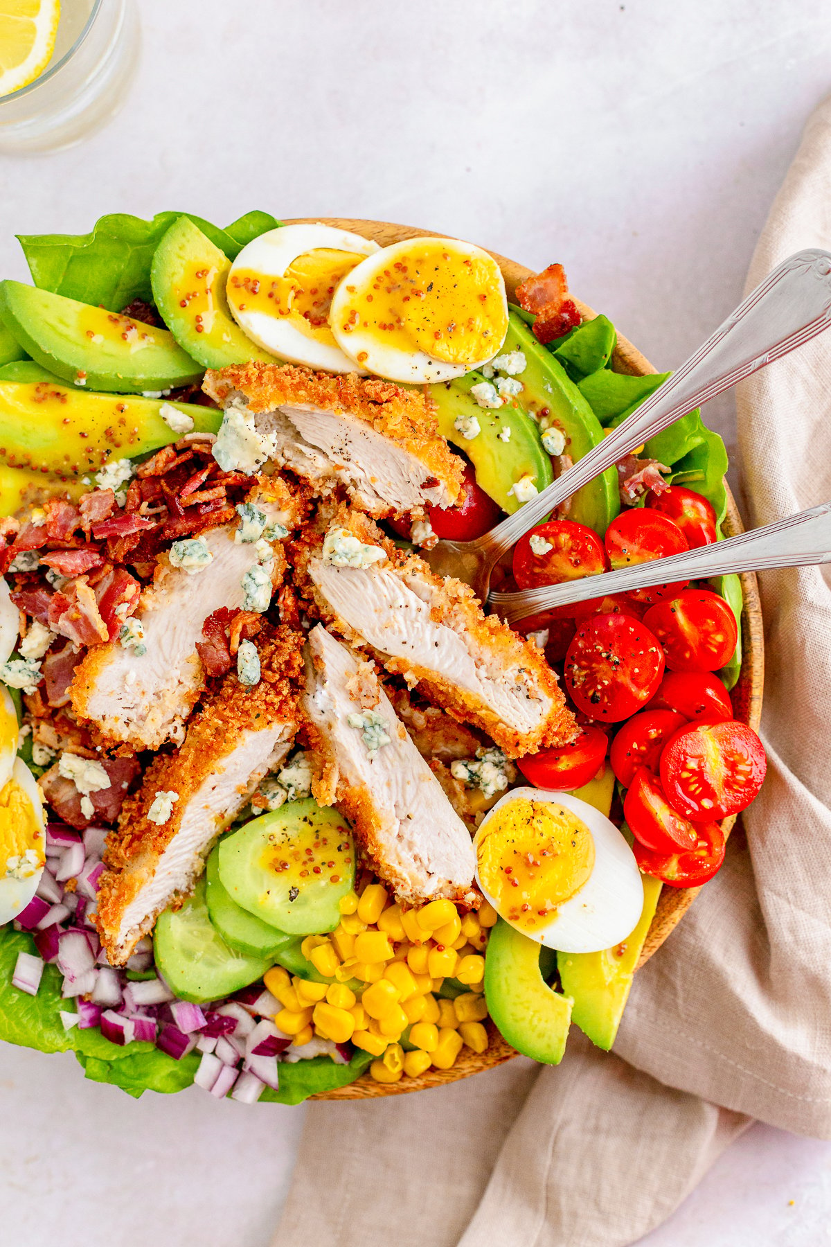 Overhead of side of Chicken Cobb Salad with forks in dish.