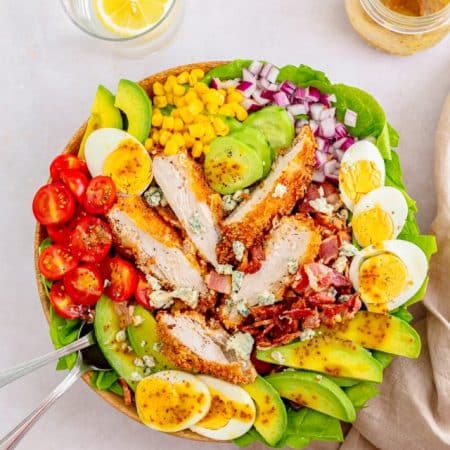 Overhead of finished Chicken Cobb Salad with forks in side.