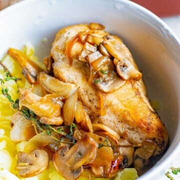 Close up of Chicken with Mushrooms in bowl with mashed potatoes.