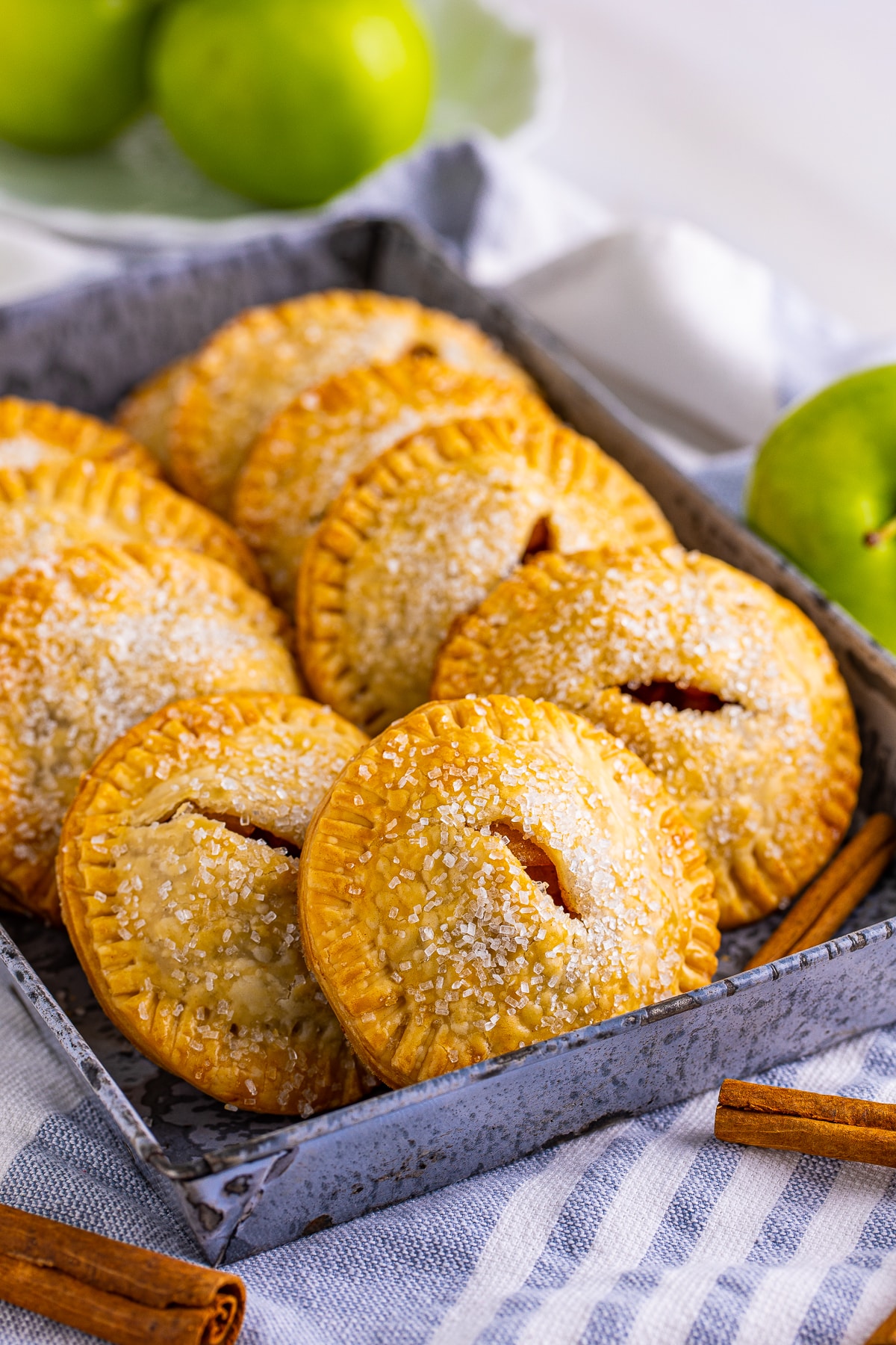 Apple Hand Pies in metal tin layered on each other.