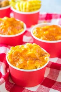 Three small cups of Chick Fil A Mac and Cheese Recipe on a red and white checkered linen napkin.